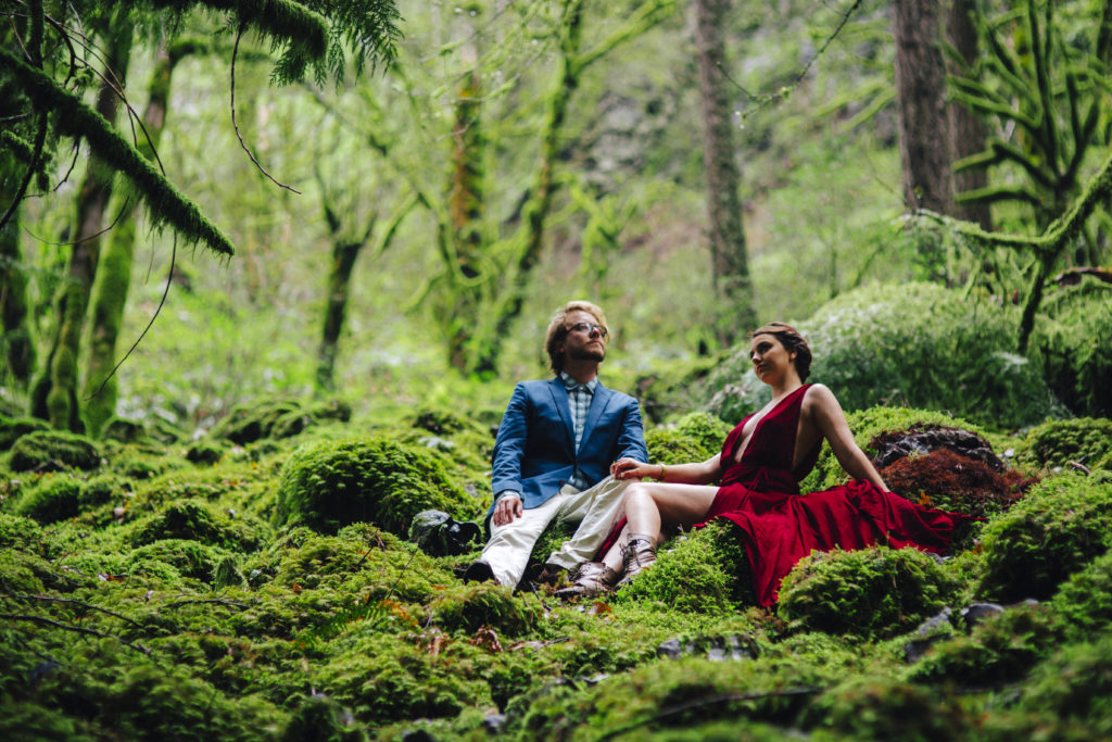 Engagment photo on a bed of moss in Cascade Locks, Oregon