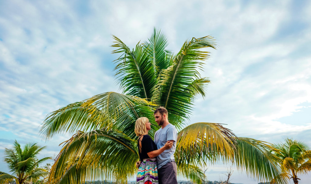 Engagement photo with a palm tree in Negril, Jamaica