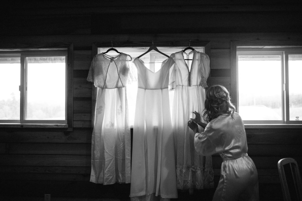 A photo of a bride with three generations of hand made wedding dresses at Home Place Farm