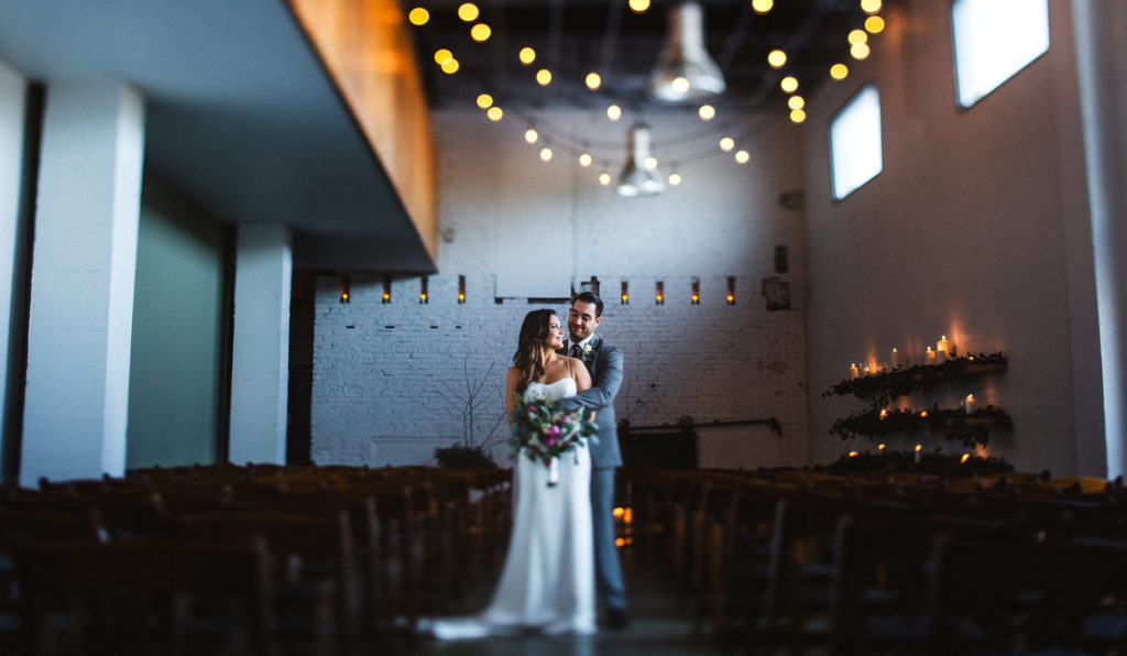 Industrial candle lit wedding photo at Classic Foods in Portland, OR