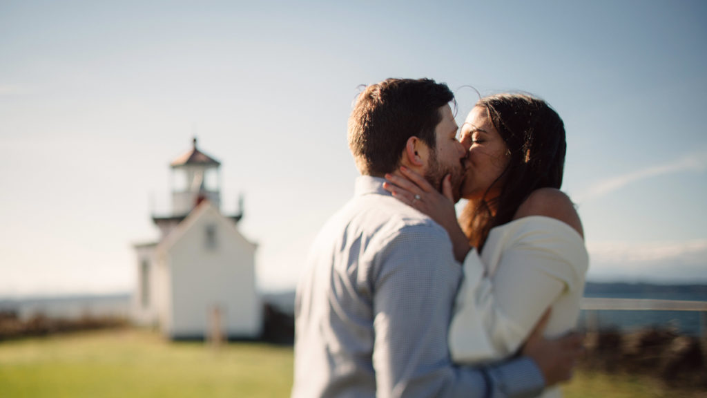 Engagement photo in Seattle, Washington with the lighthouse at Discovery Park