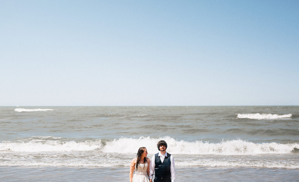 Bride and groom after jumping in the water of Lake Michigan