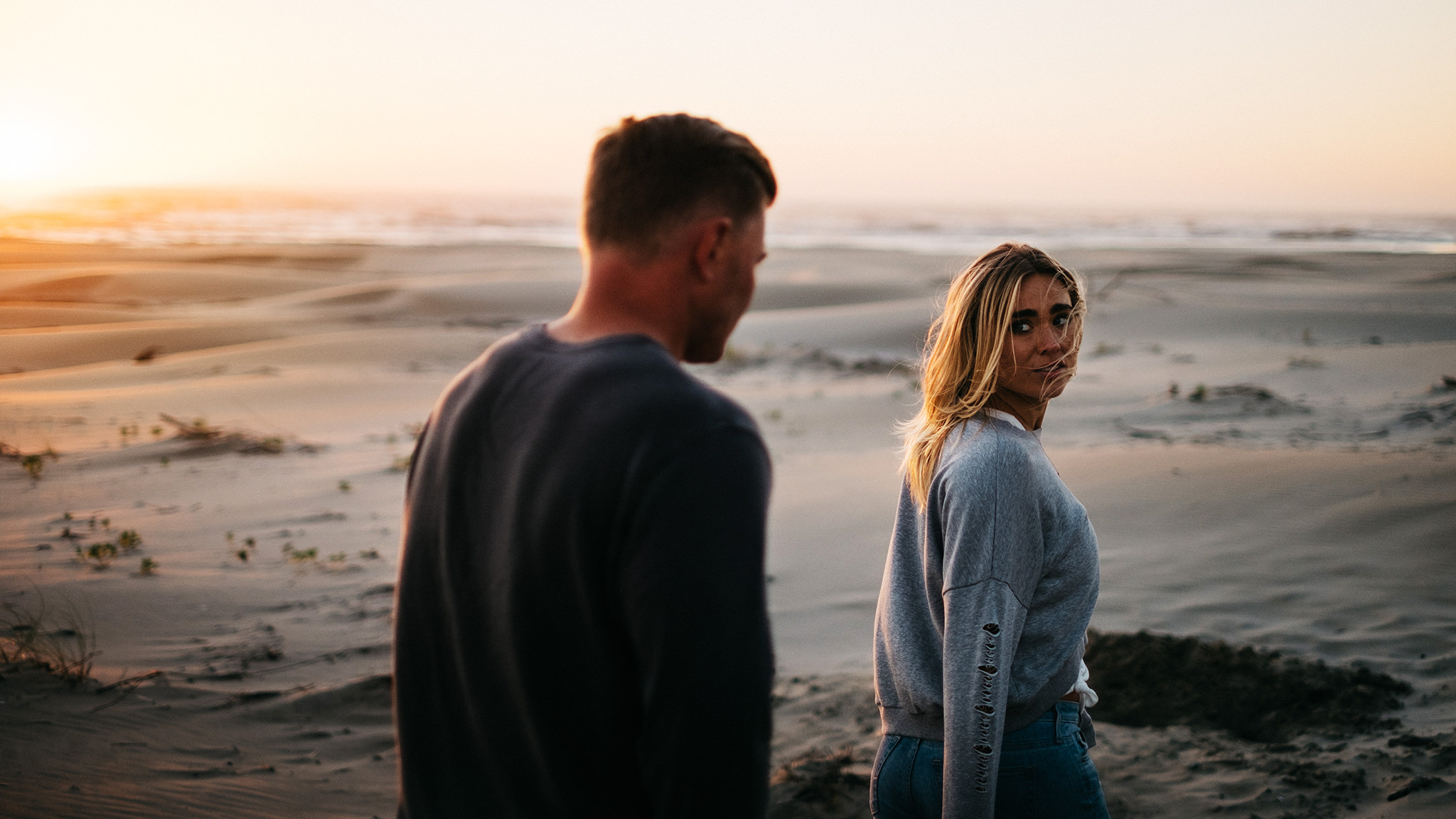 Sunset engagement photo at Driftwood Beach in Seal Rock, Oregon