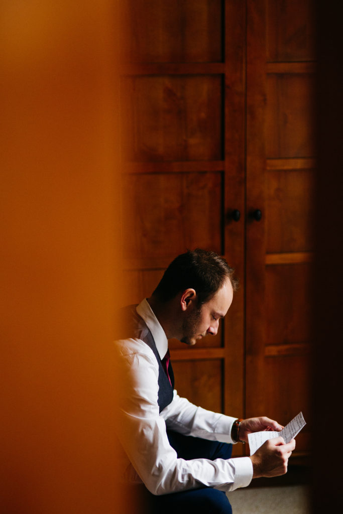 Groom reading a letter from the bride on their wedding day at Nita Lake Lodge