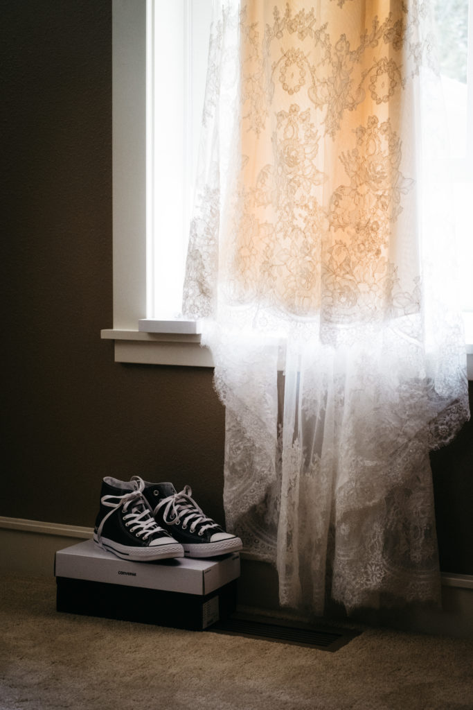 A wedding detail photo of a wedding dress and shoes