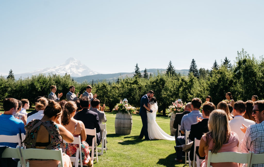 A bride and groom's first kiss at their Mt View Orchards wedding