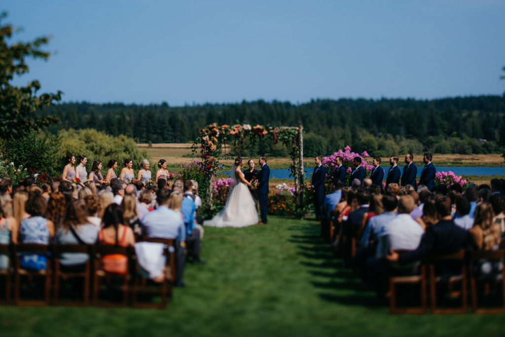 A wedding ceremony at Fireseed catering overlooking the lake