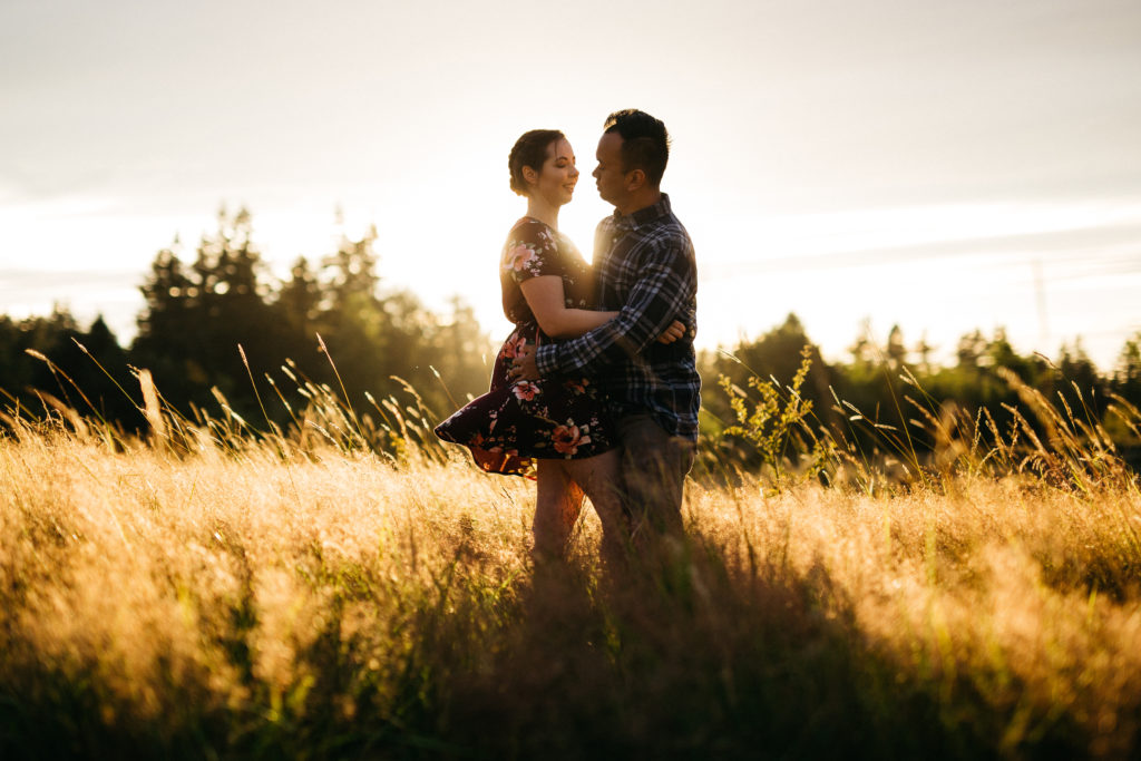 Engagement photo during the golden hour in a field at Powell Butte in Portland, OR