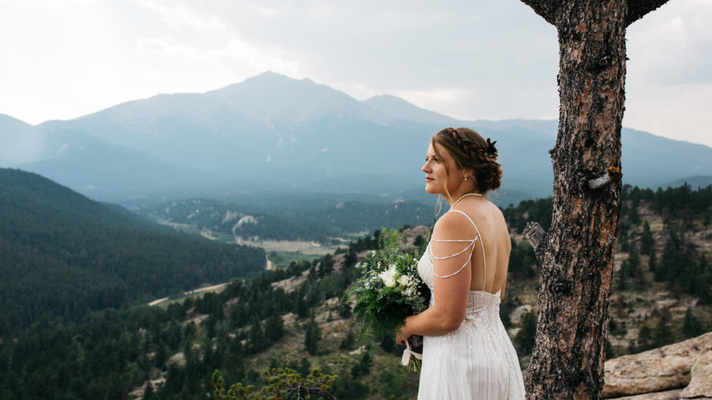 A bride looking out over the mountain range in Rocky Mountain National Park