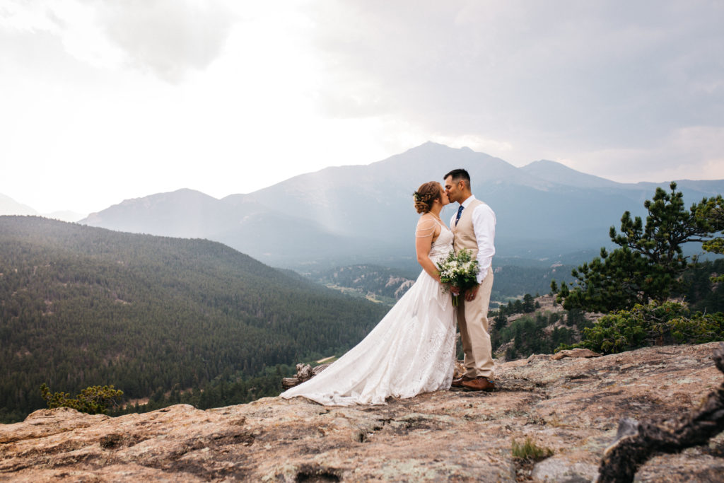 A bride and groom kiss during their elopement in Rocky Mountain National Park