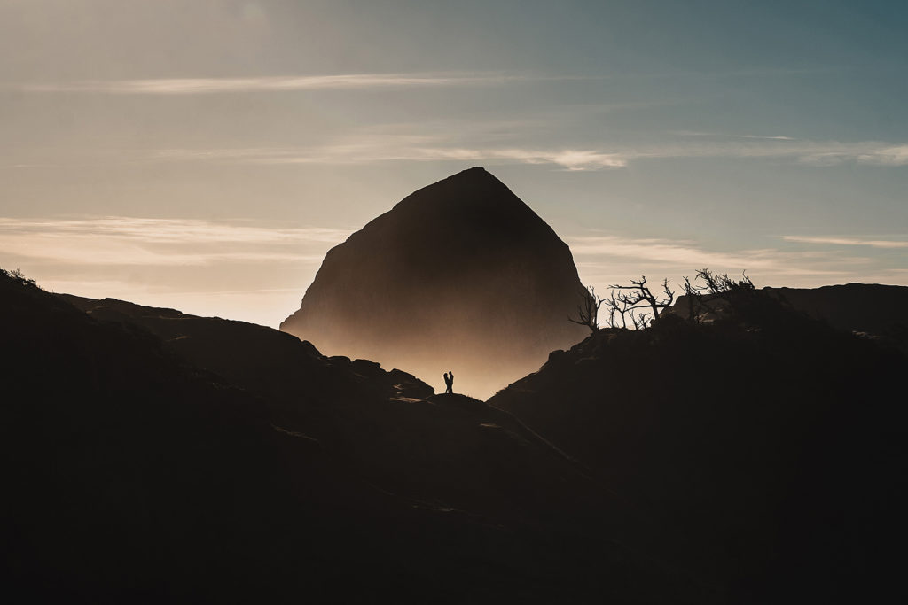 Silhouette photo of a couple getting engaged at Cape Kiwanda on the Oregon coast