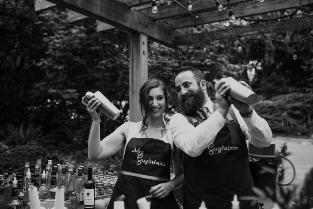 Bride and groom bartending at their Wisteria Hall wedding in Seattle, WA