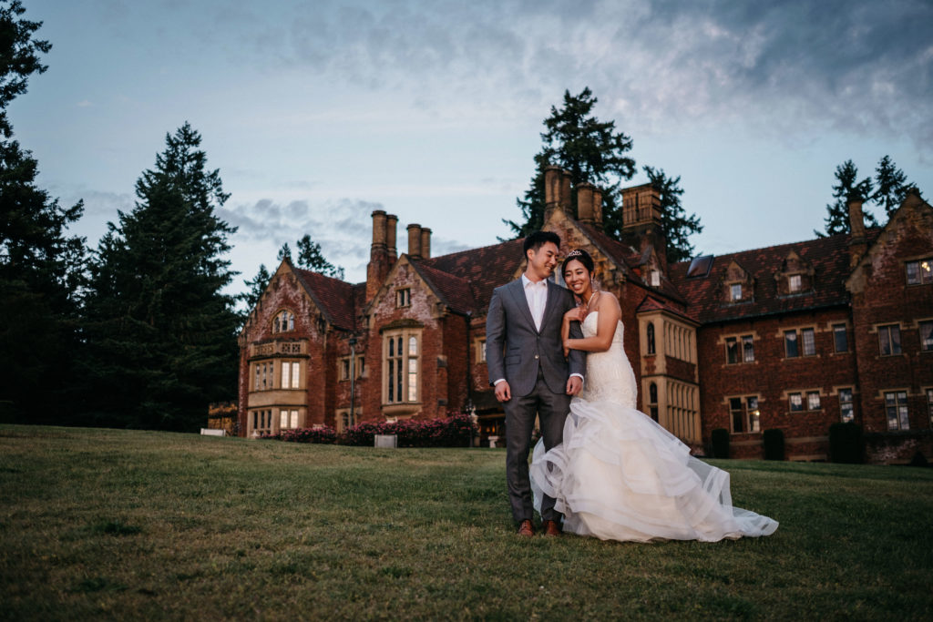 Bride and groom in front of Thornewood Castle