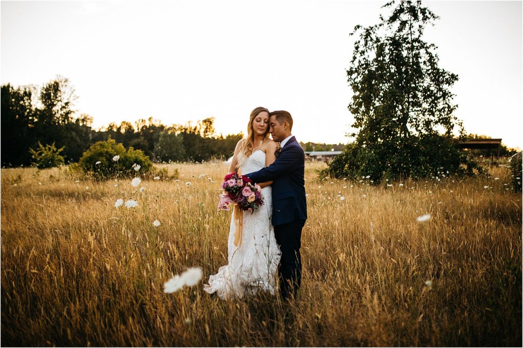 Bride and groom at sunset in the fields at the UW Center for Urban Horticulture