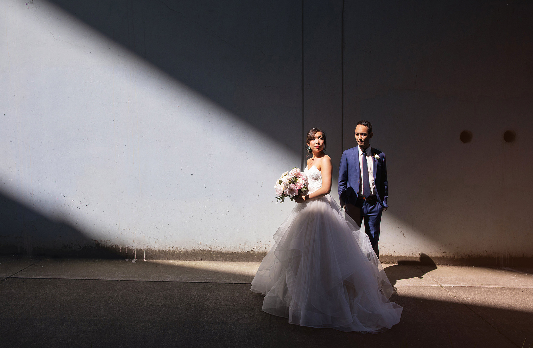 bride and groom artistic portrait in a shaft of light in portland oregon