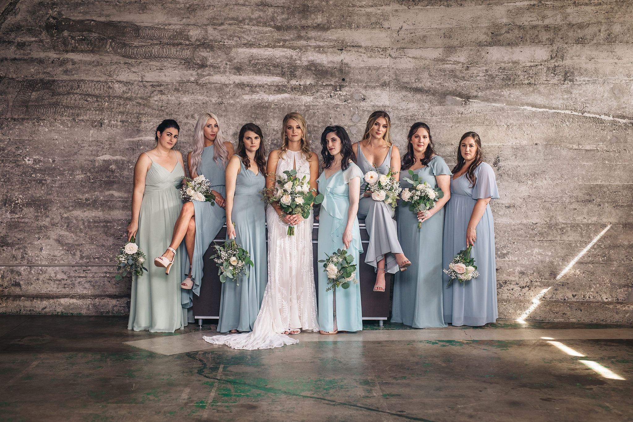 An industrial wedding photo of a bride and her bridesmaids in the clubroom at the Portland wedding venue, Leftbank Annex