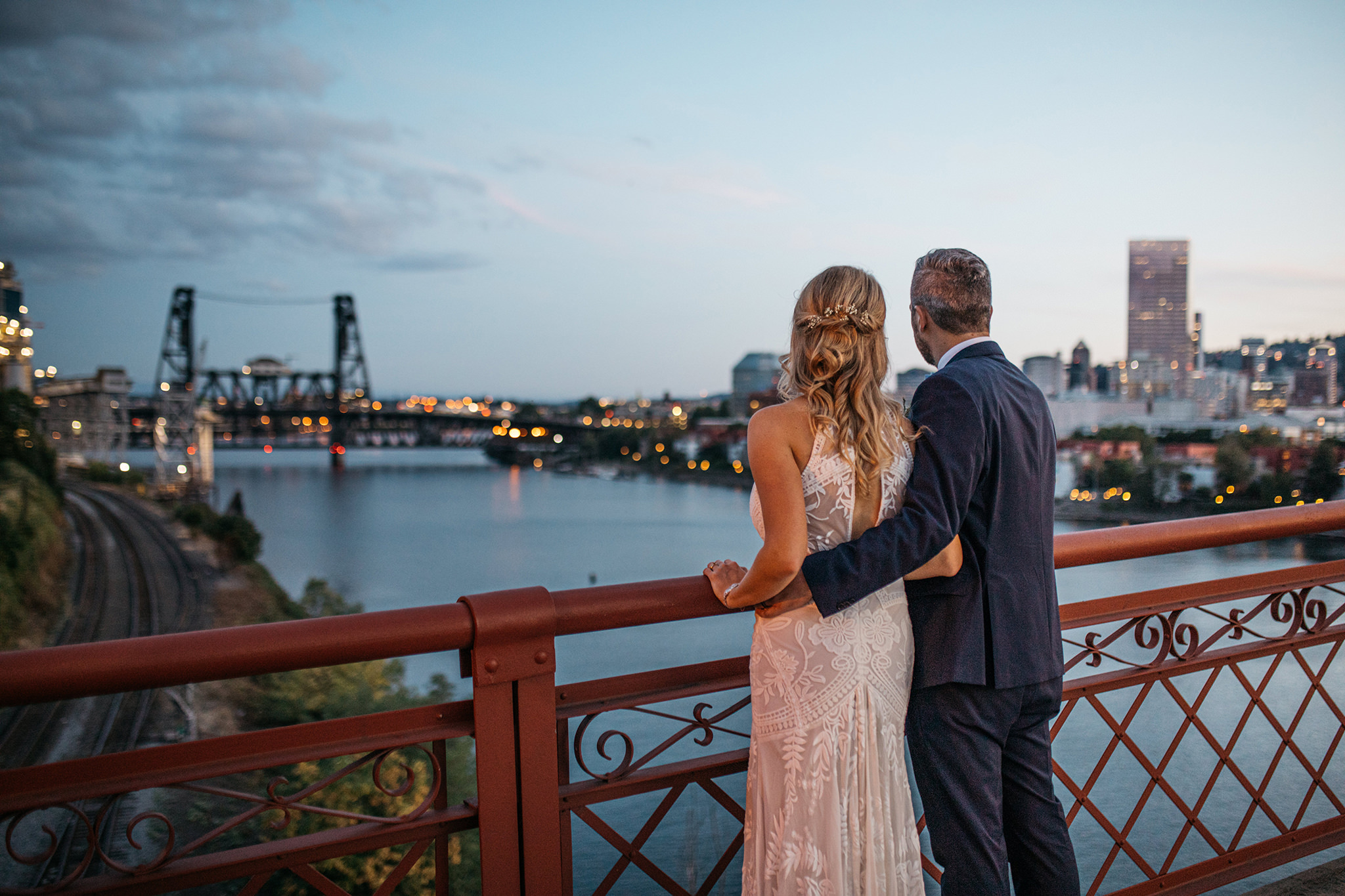 A wedding photo on a bridge in Portland, Oregon overlooking downtown