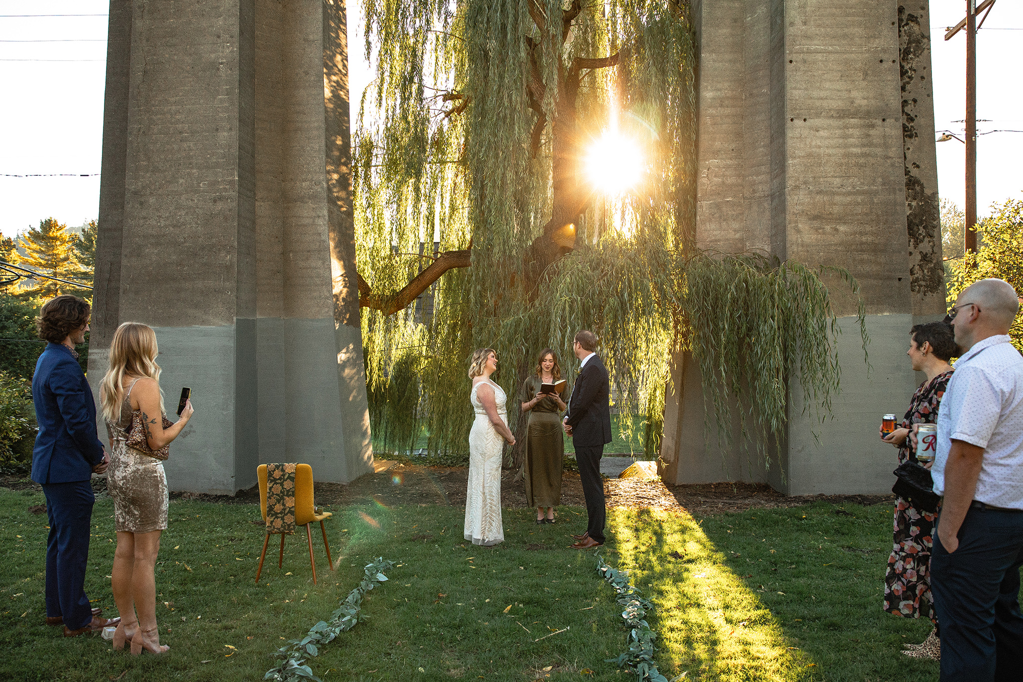 A golden hour wedding ceremony at Cathedral Park in Portland