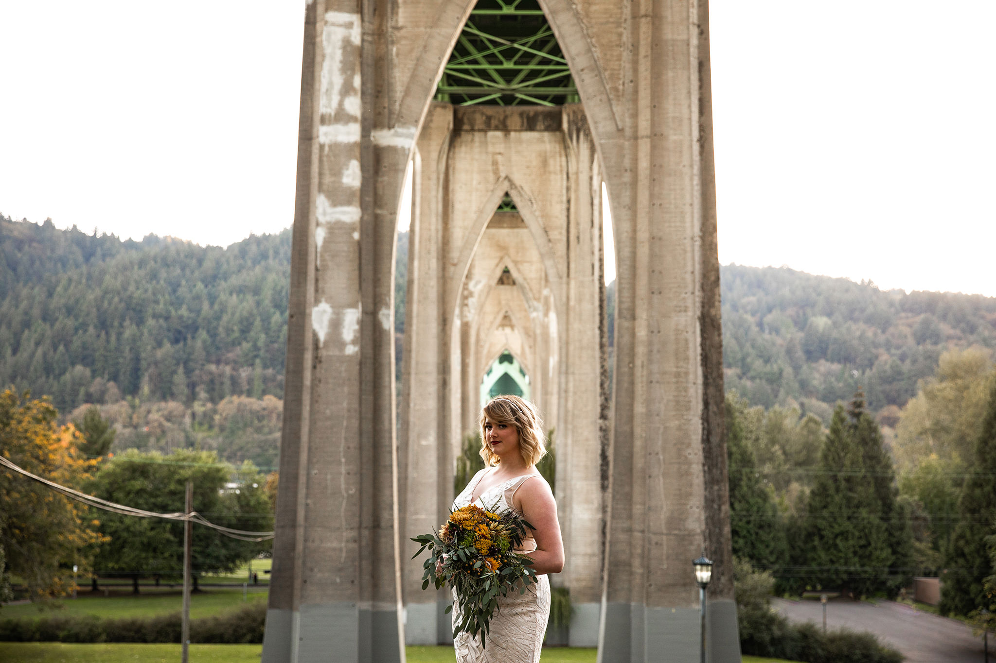 A portrait of a bride on her wedding day at Cathedral Park in Portland, Oregon