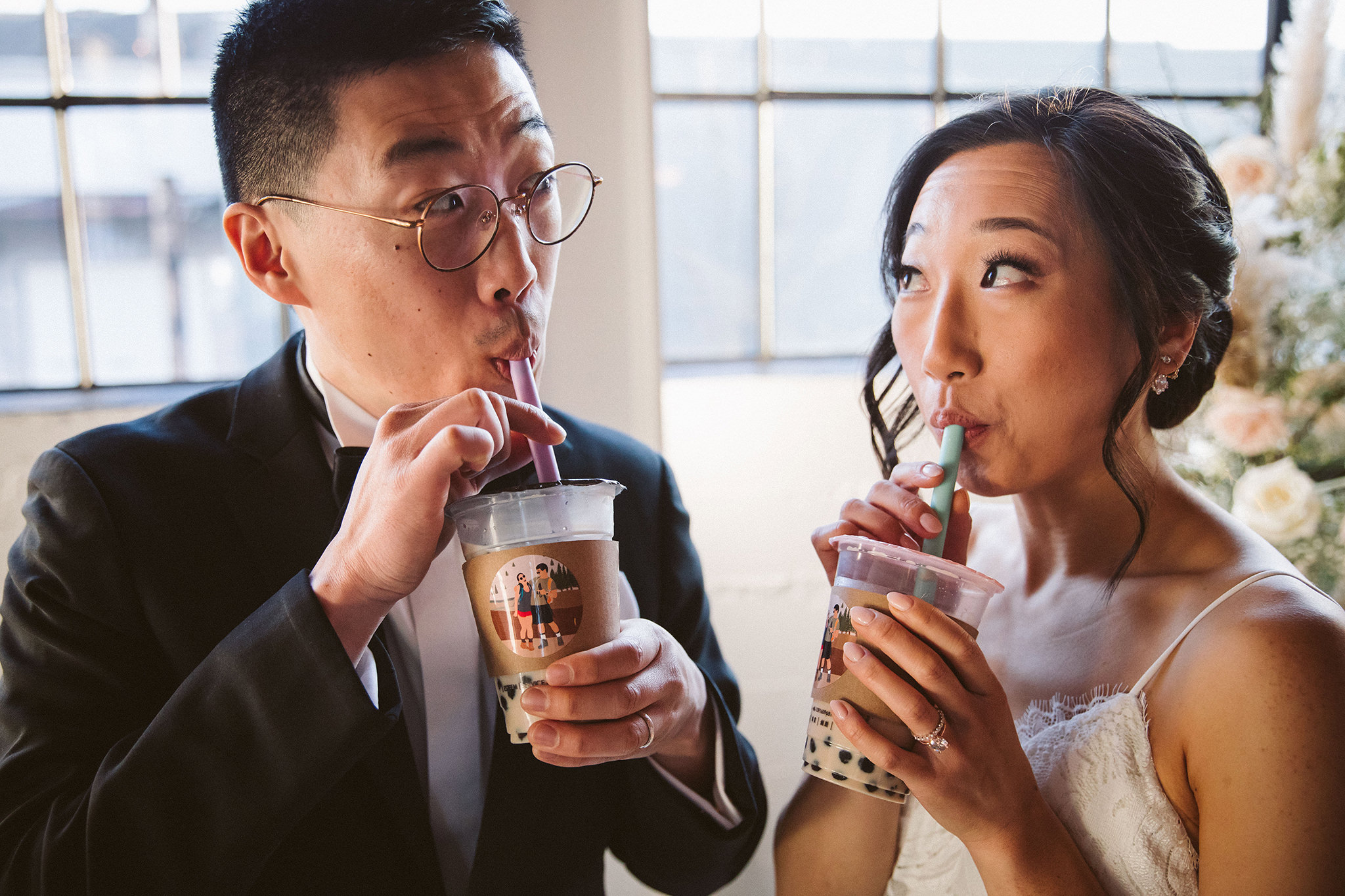 A bride and groom drinking custom boba tea from Ding Tea Williams at their wedding reception at Castaway Portland