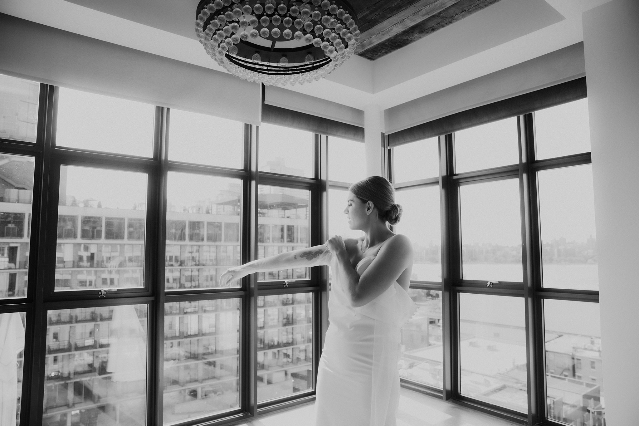 a bride getting into her dress at the Wythe Hotel in Brooklyn, New York