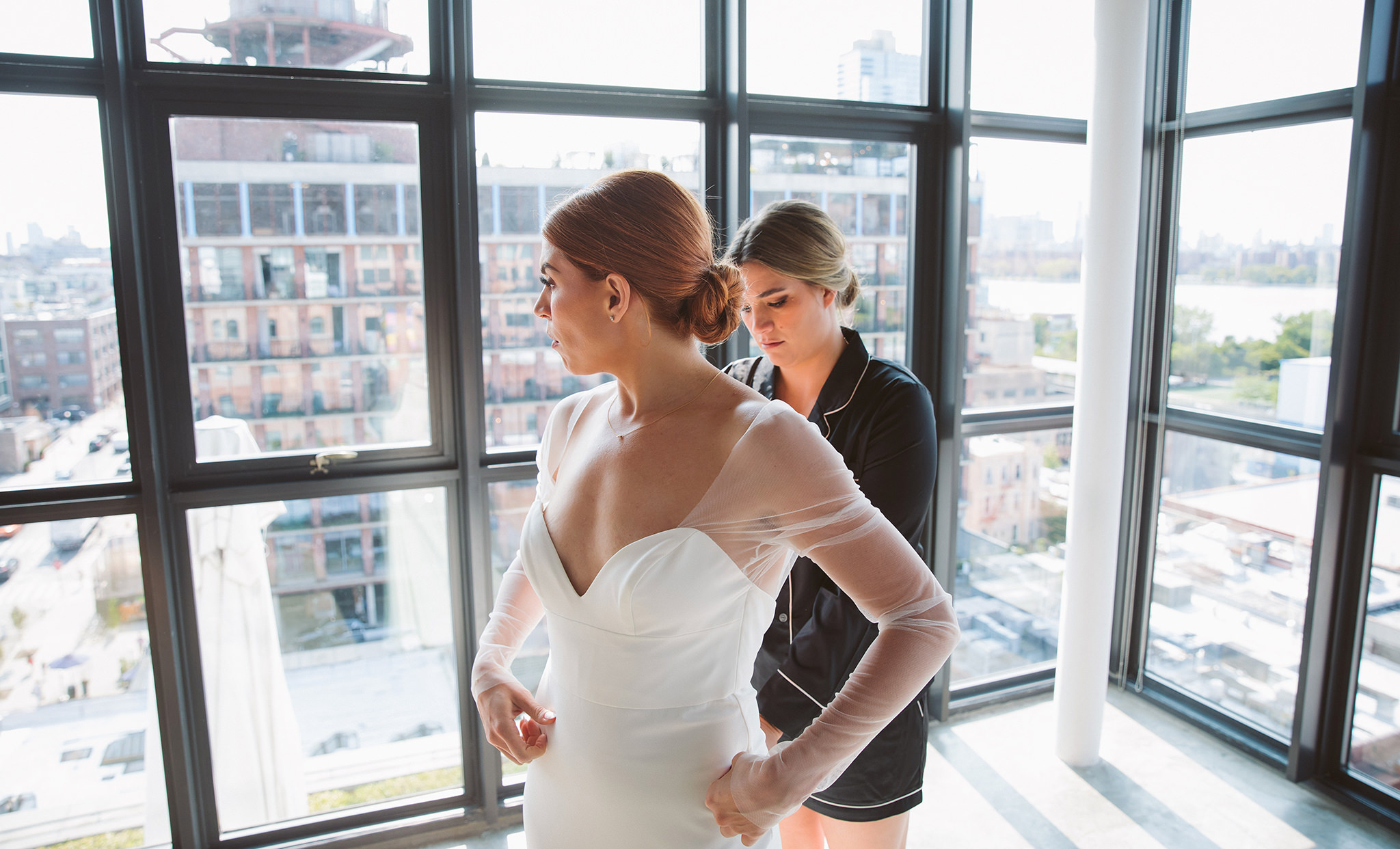 A bride putting on her wedding dress in a suite at the Wythe Hotel in Williamsburg