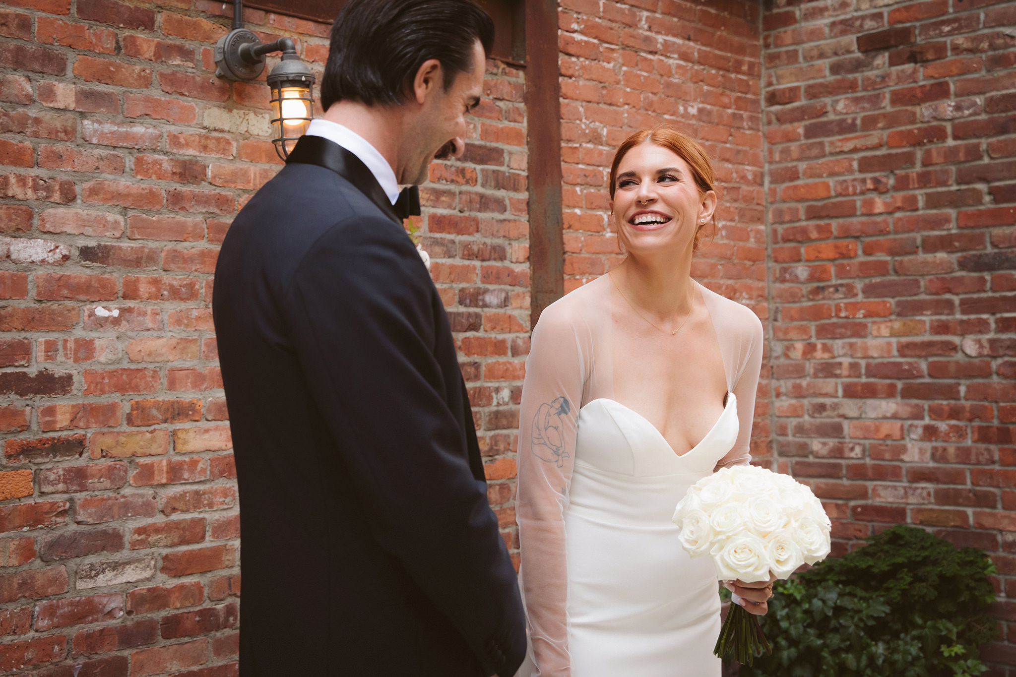 A bride and groom in the courtyard at their Wythe Hotel wedding