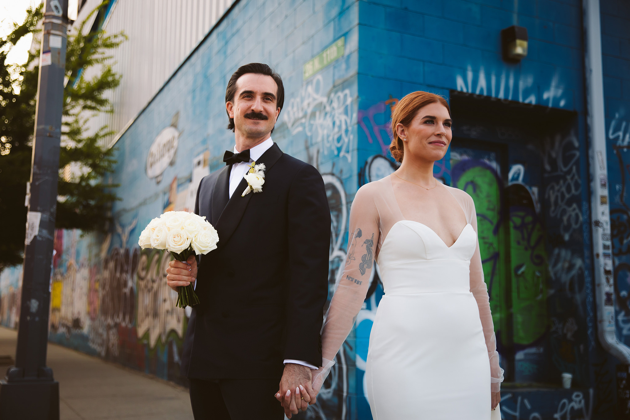A vibrant wedding photo on the street outside of the Wythe Hotel 