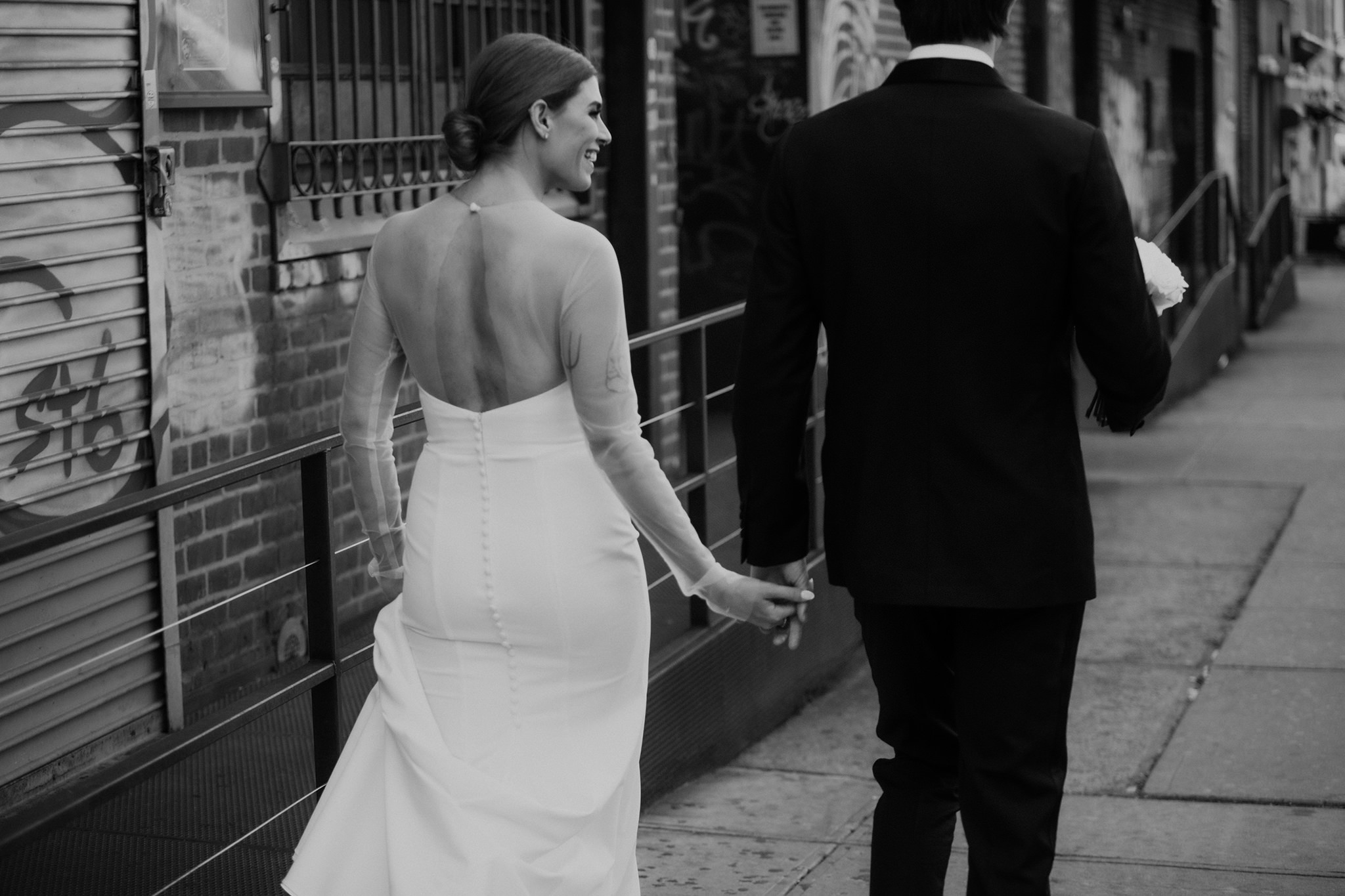 A bride and groom walking around Williamsburg on their Wythe Hotel wedding day