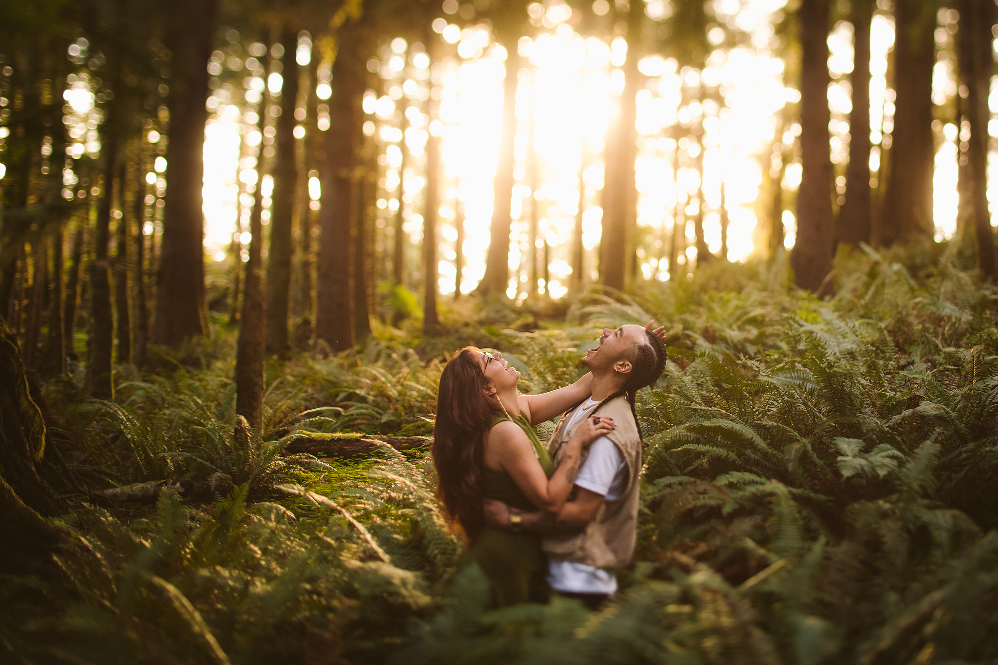 A couple laughing in the woods near Ecola State park