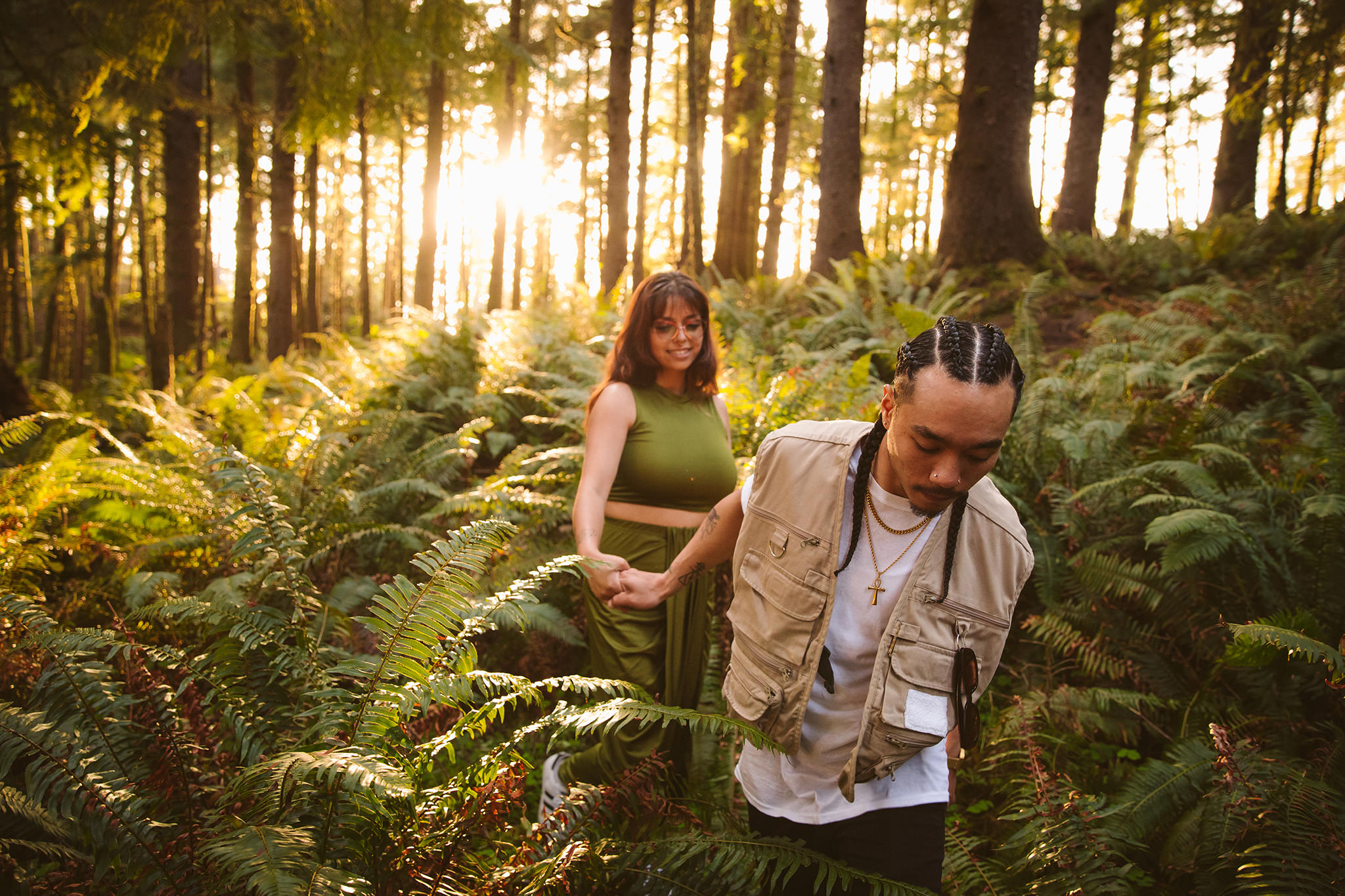 A couple walking through the woods during their Cannon Beach proposal session