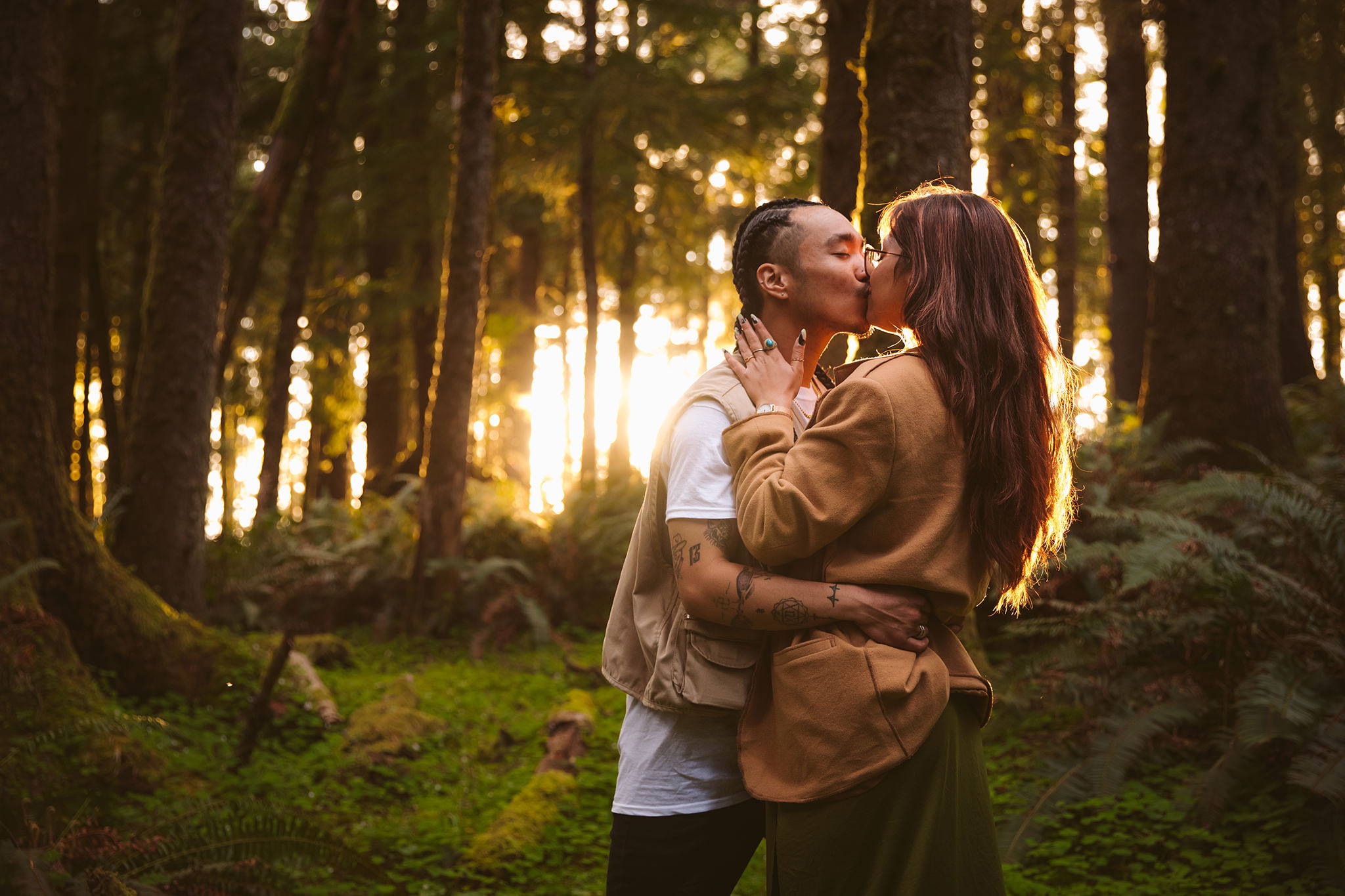 A couple kissing during golden hour at their Oregon coast engagement session
