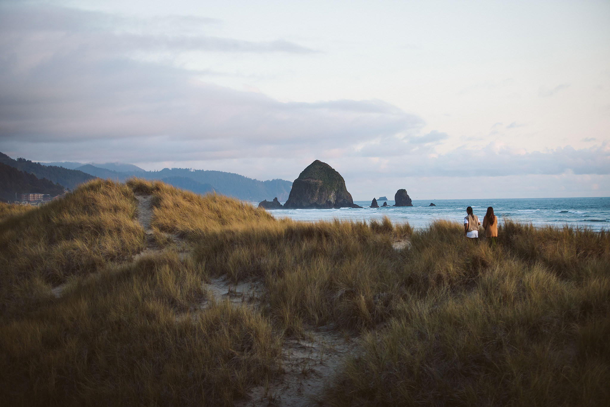 A couple walking in the sane dunes at Cannon Beach