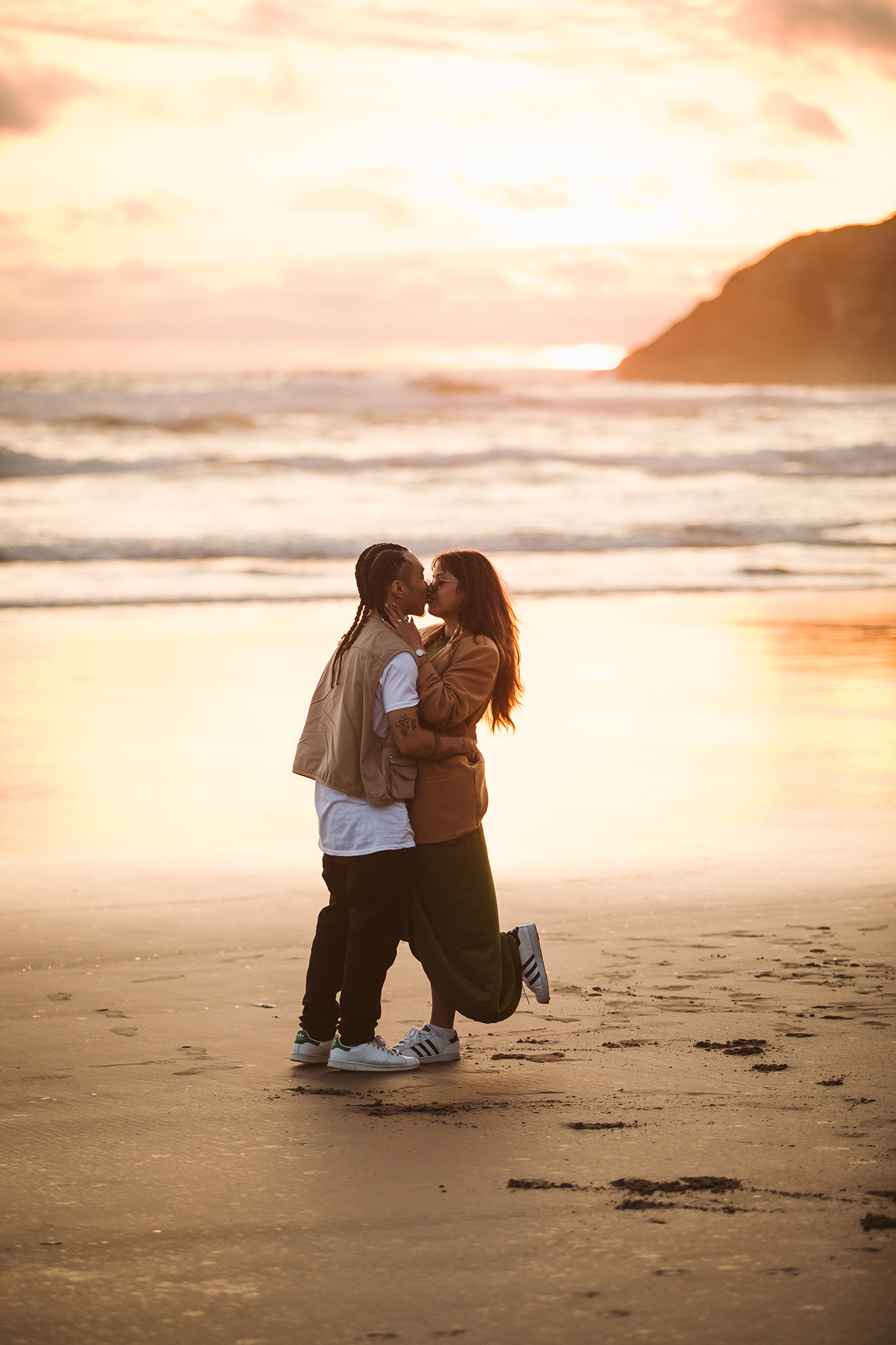 A couple kissing at sunset on Cannon Beach