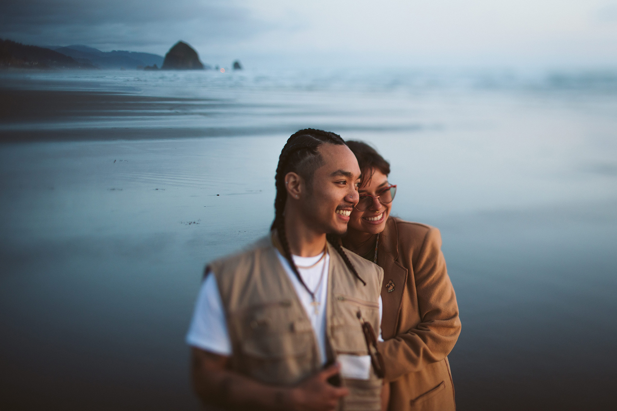An engagement photo at dusk on Cannon Beach in Oregon