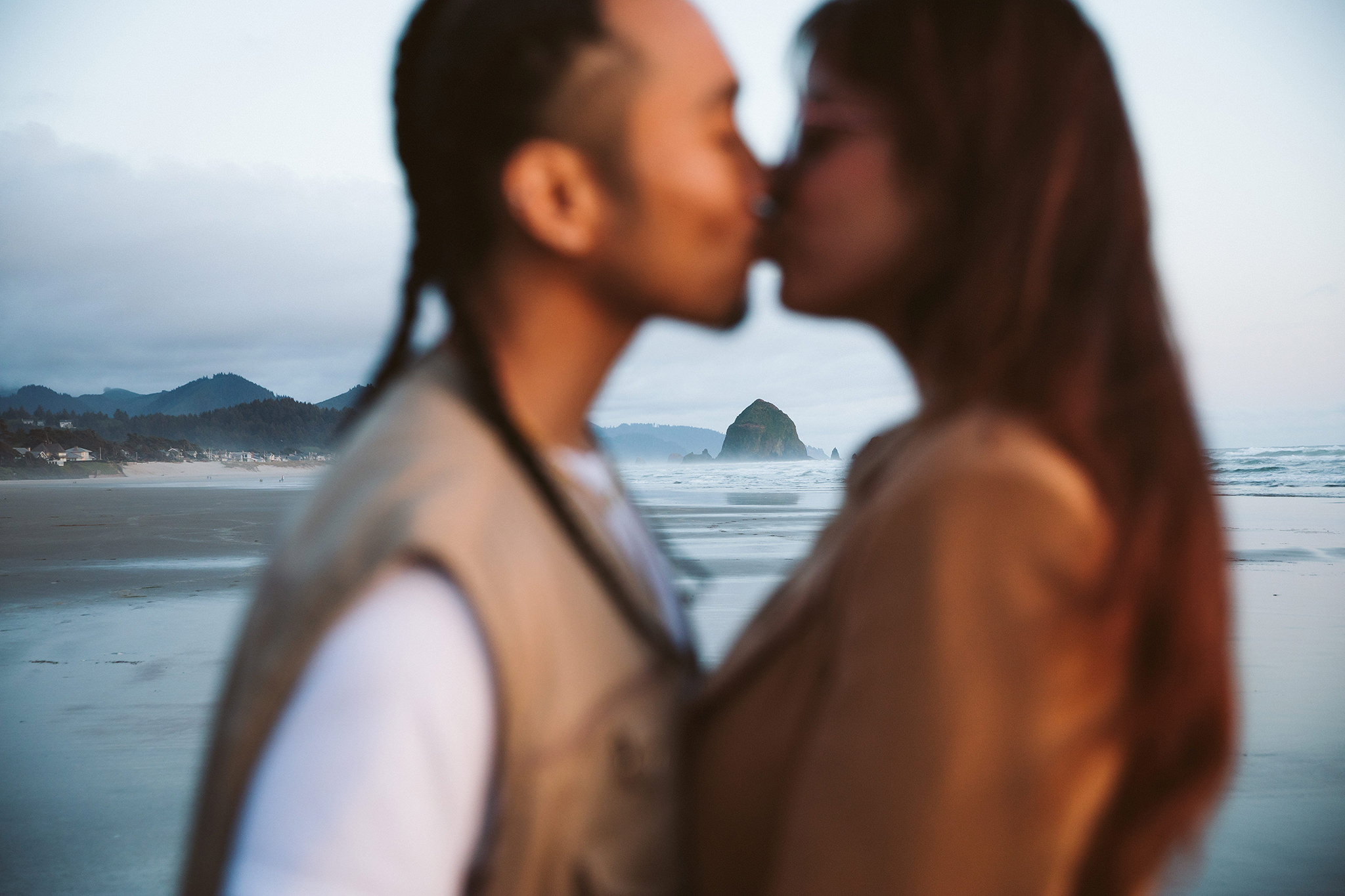 An engagement photo with Haystack Rock in Cannon Beach, Oregon