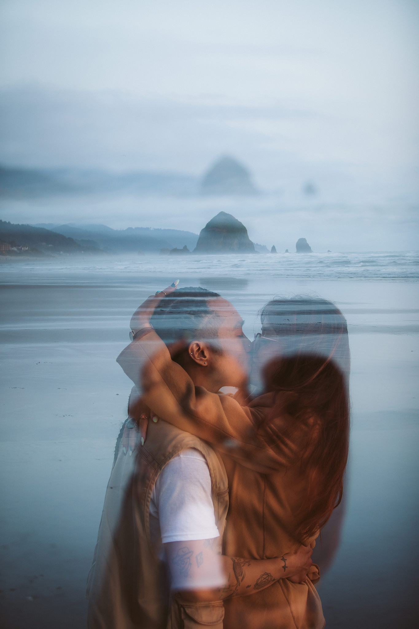 A creative engagement photo on Cannon Beach at sunset
