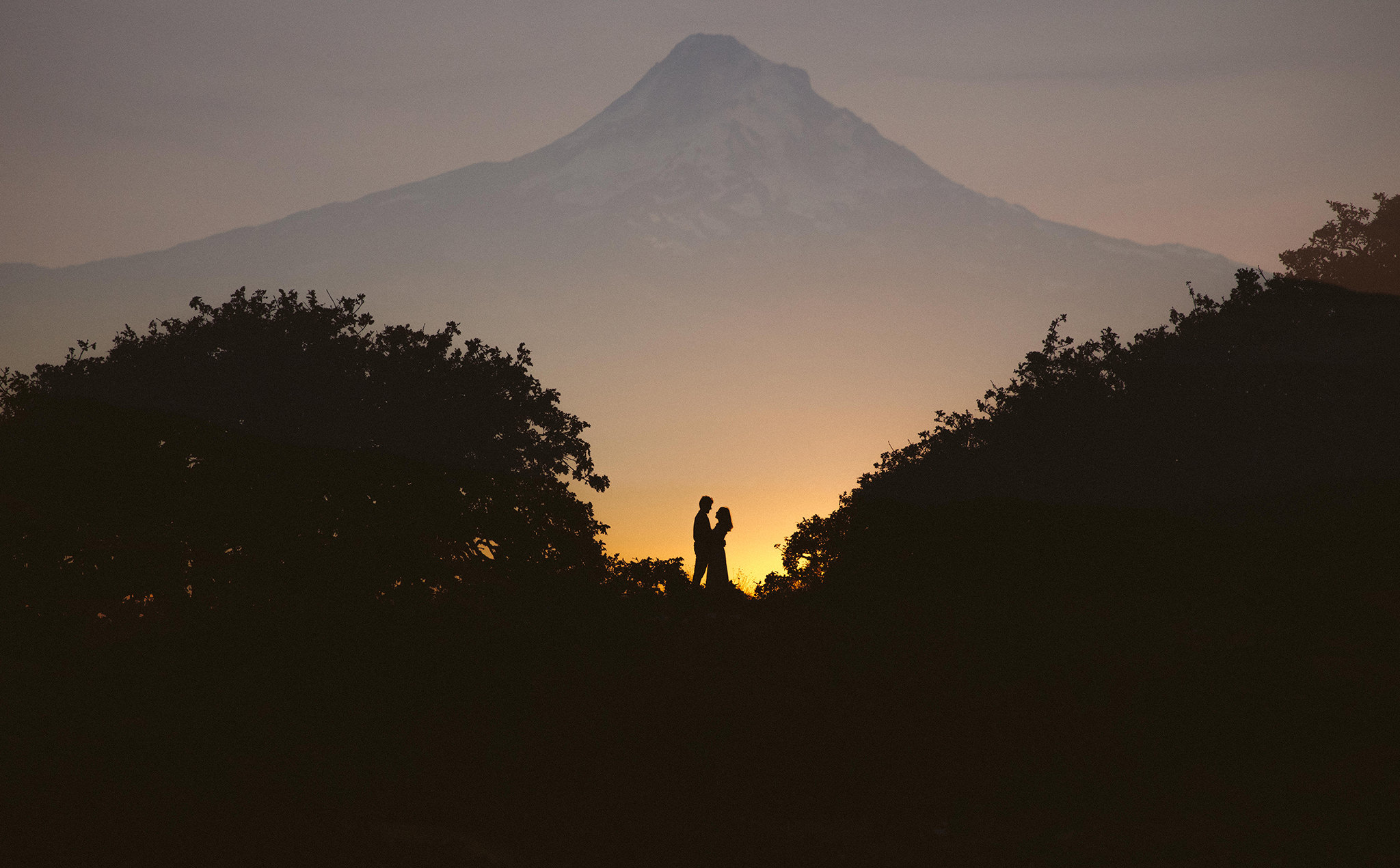 A creative double exposure sunset engagement photo on Mt Hood in Oregon