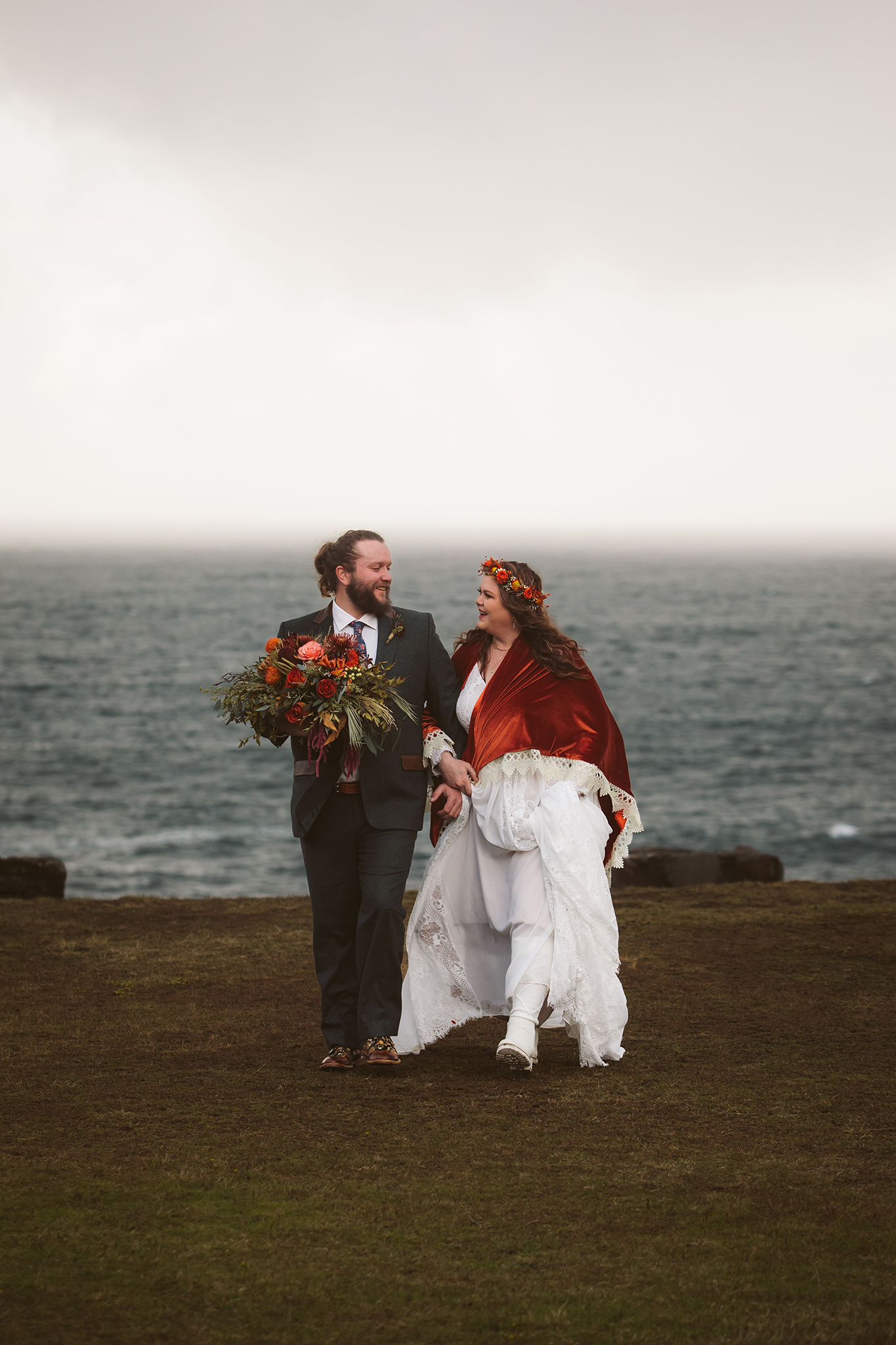 A wedding photo of a bride and groom walking on the Oregon coast in Coos Bay at Shore Acres state park