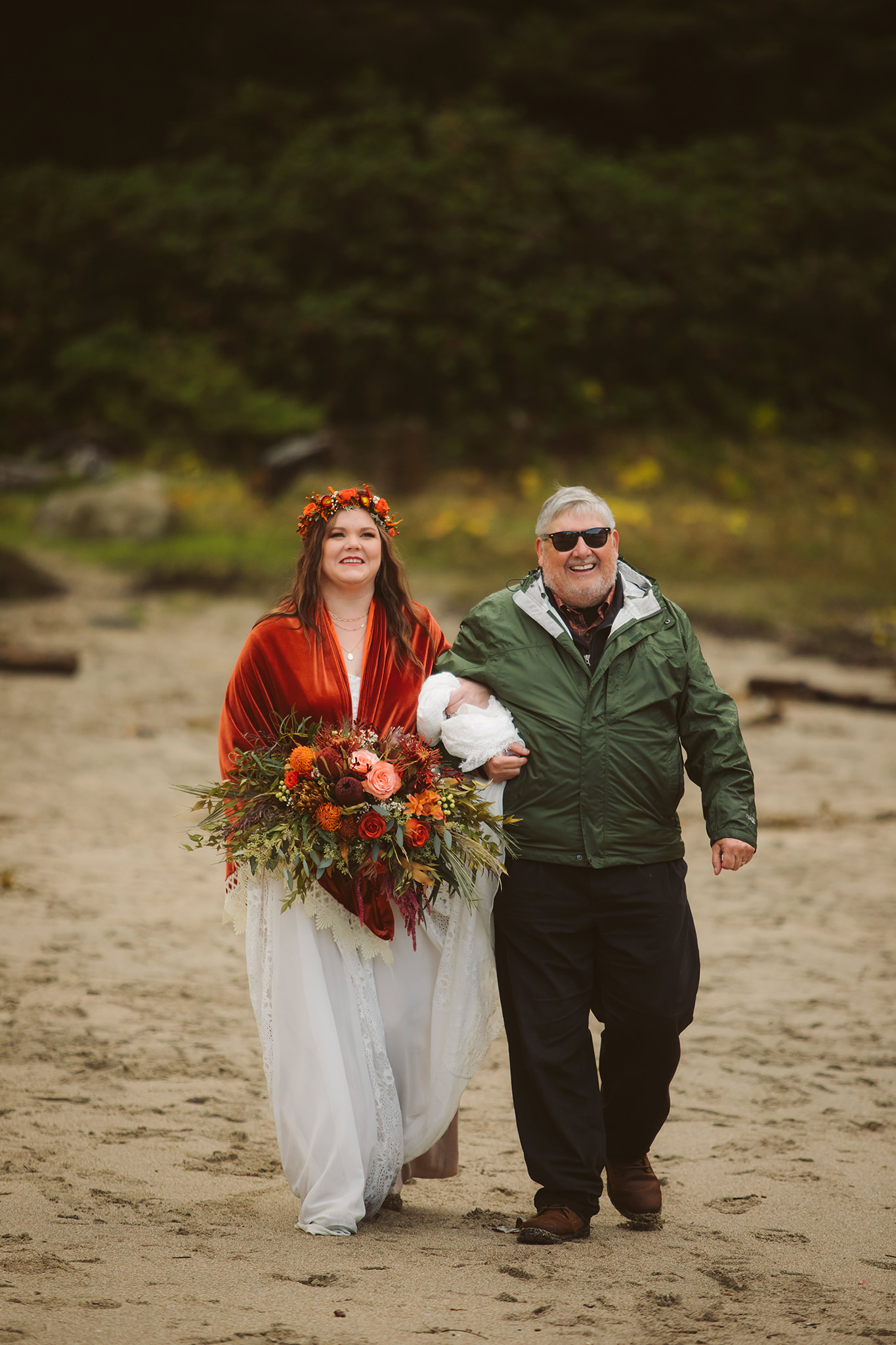 A father walking a bride down the aisle on the beach at Shore Acres state park