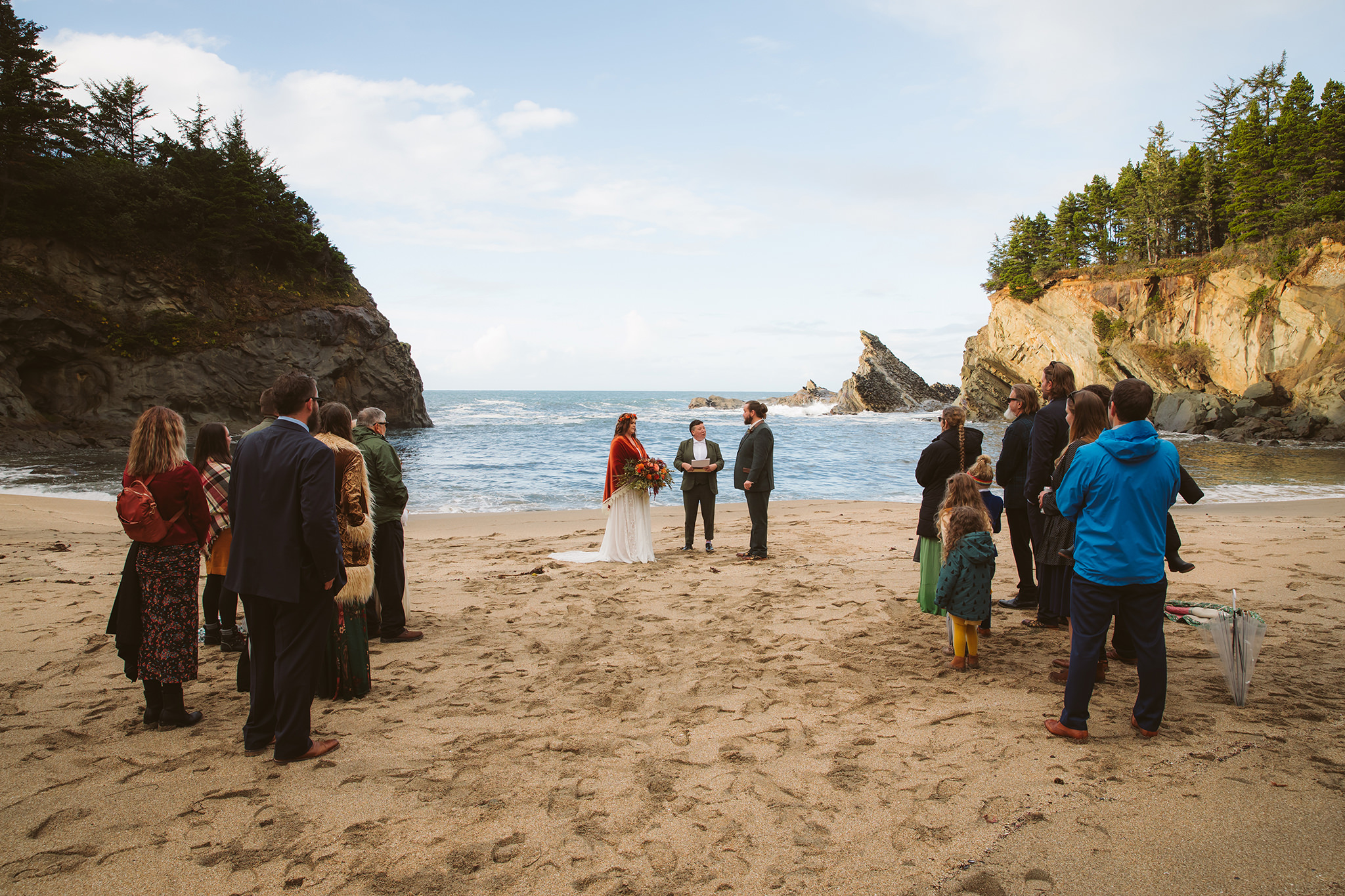 A fall wedding ceremony on Simpson beach at Shore Acres State Park in Coos Bay, Oregon