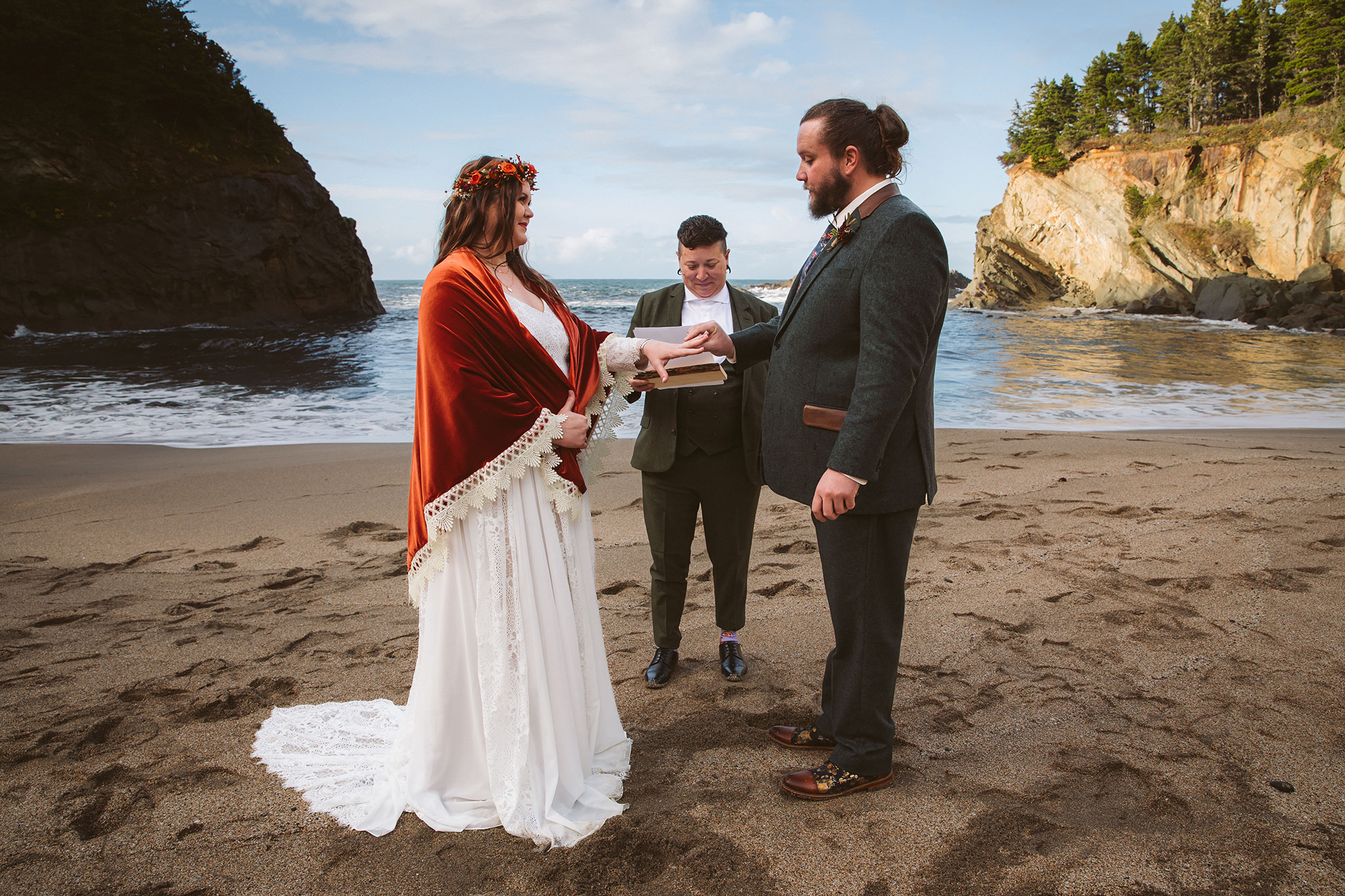 A bride and groom exchanging rings during their elopement ceremony on Simpson beach 