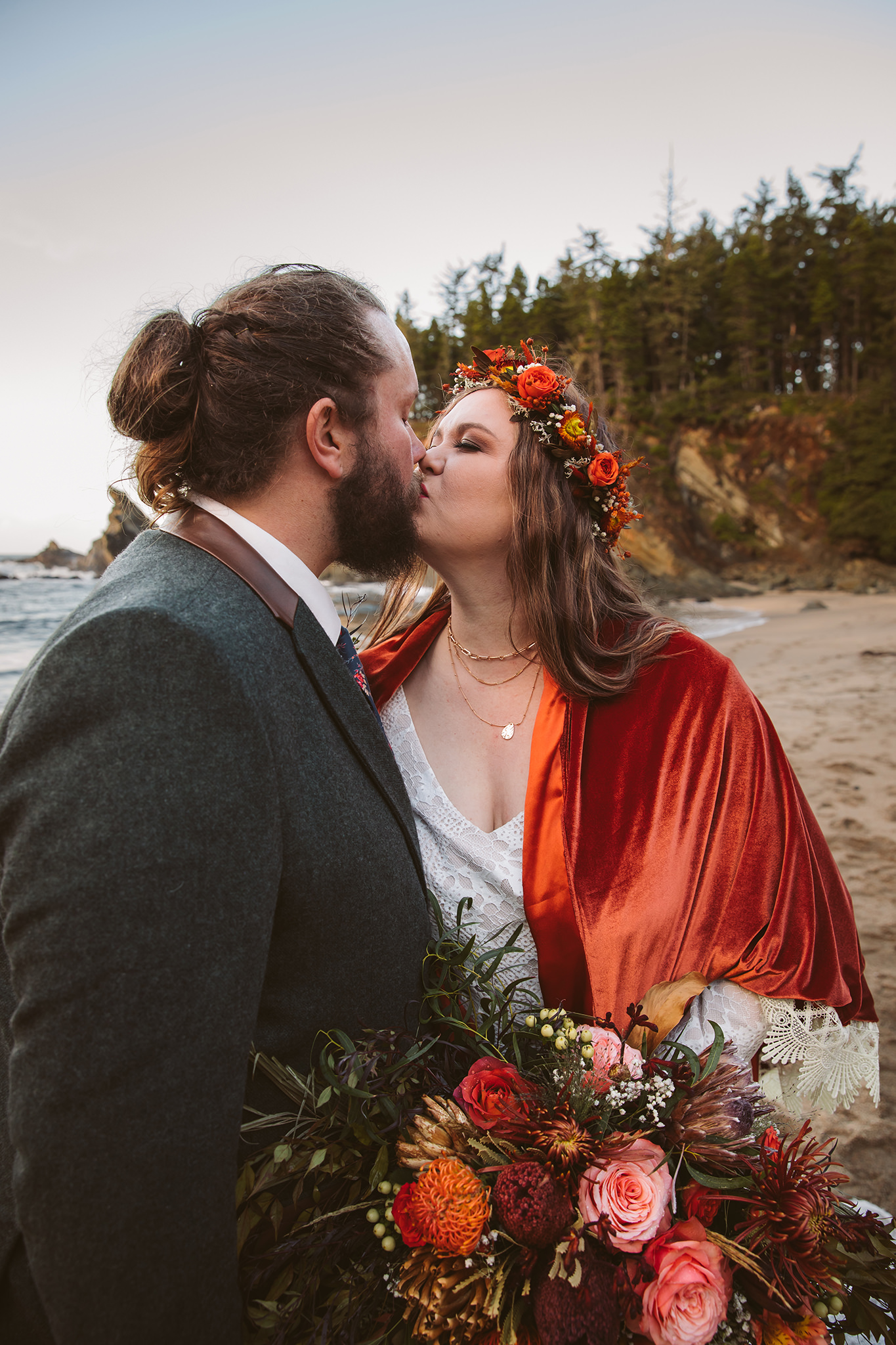 A bride and groom kissing during their Oregon coast elopement