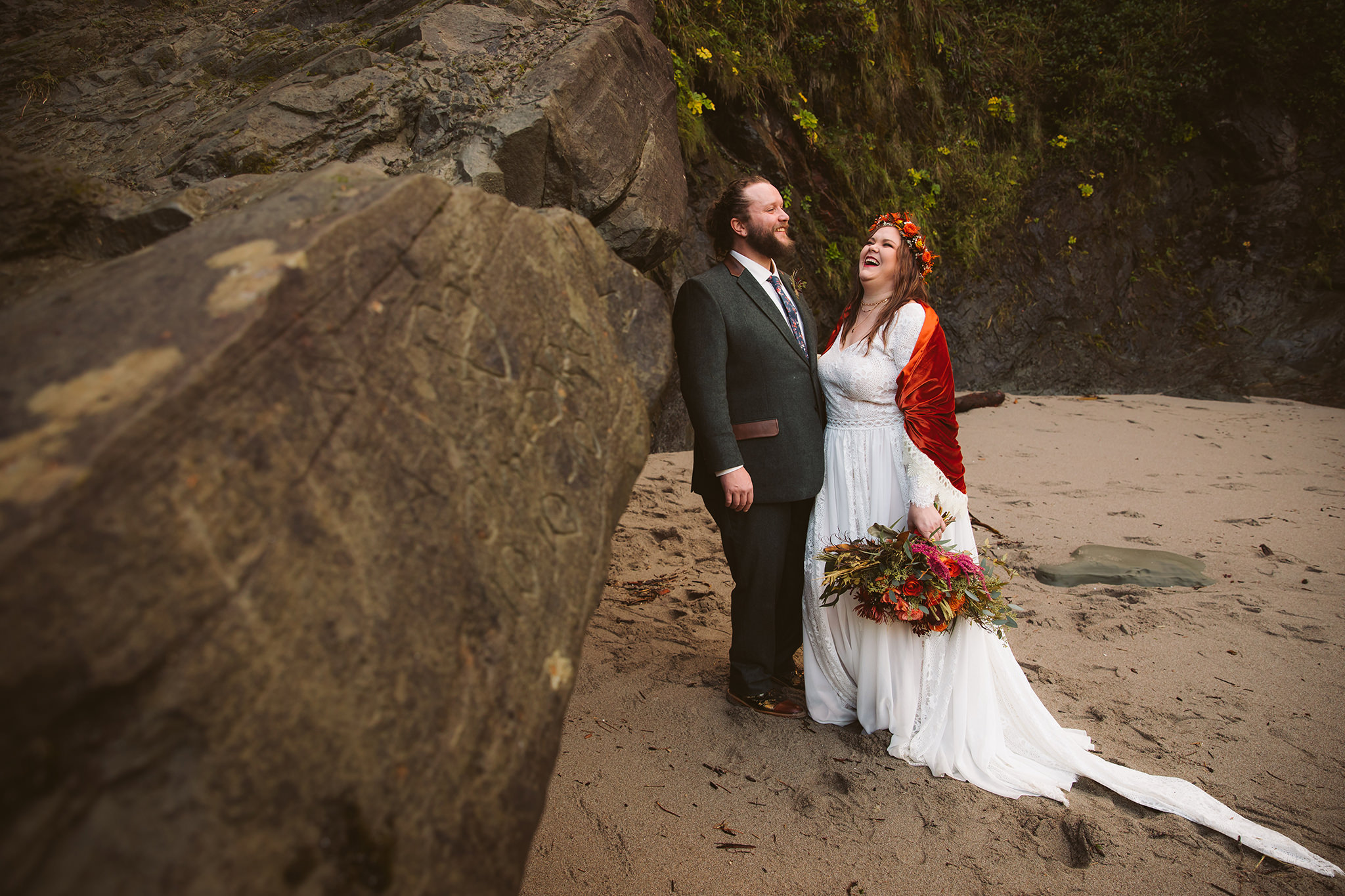 A couple laughing on the beach at their Shore Acres state park elopement