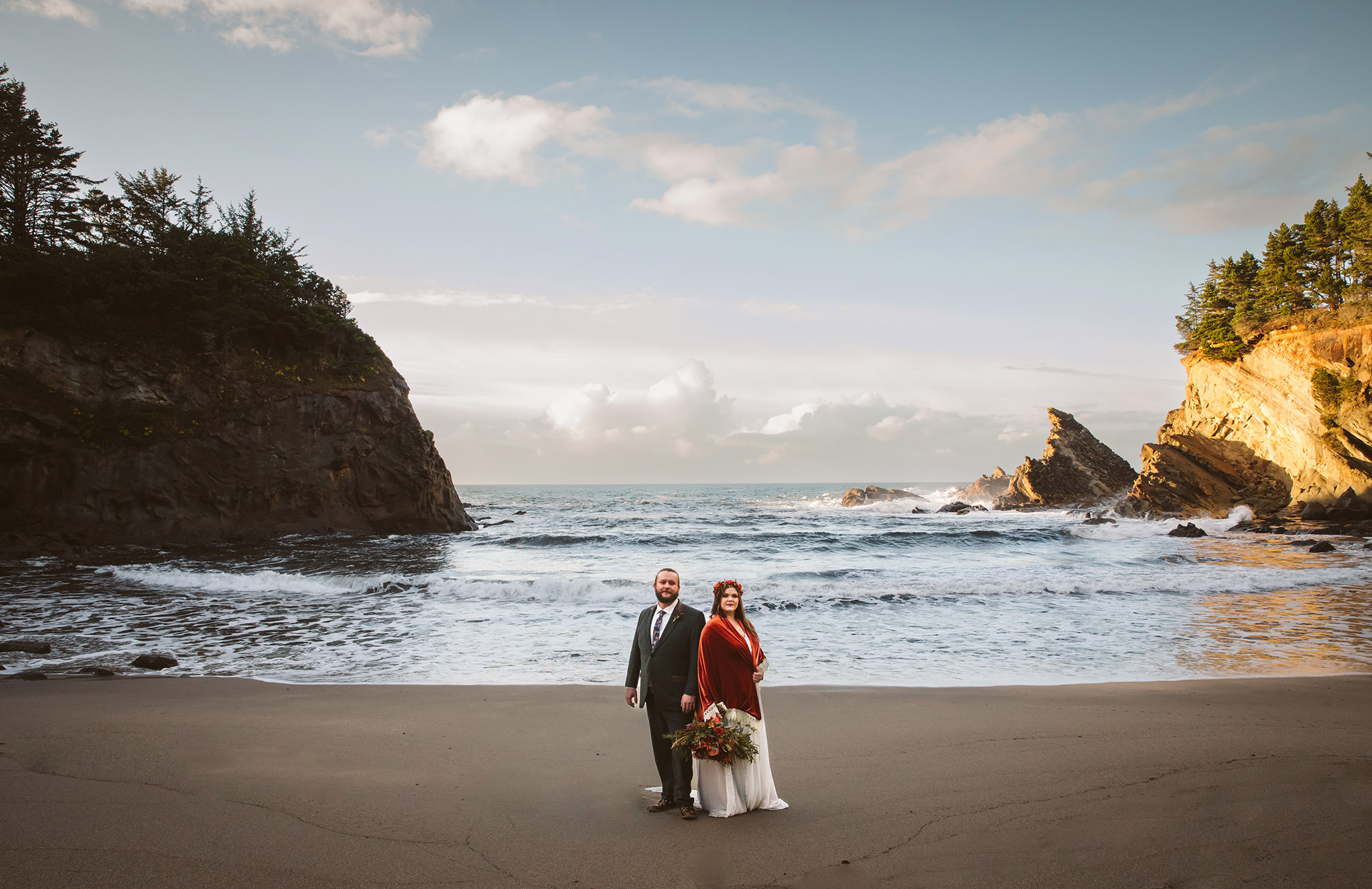 A wedding photo of a bride and groom on the beach at Shore Acres state park 