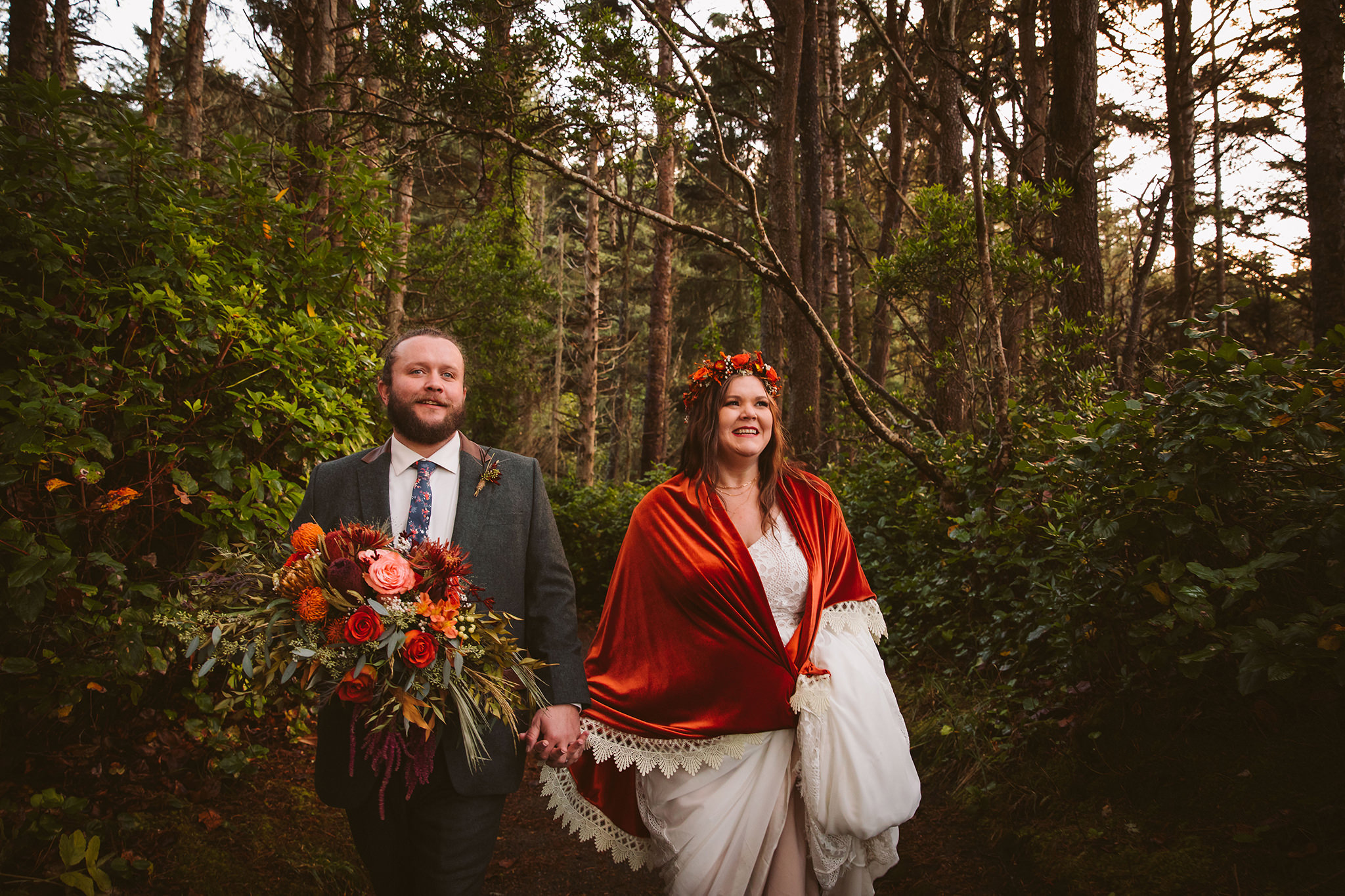 A couple walking through the woods during their Oregon forest elopement
